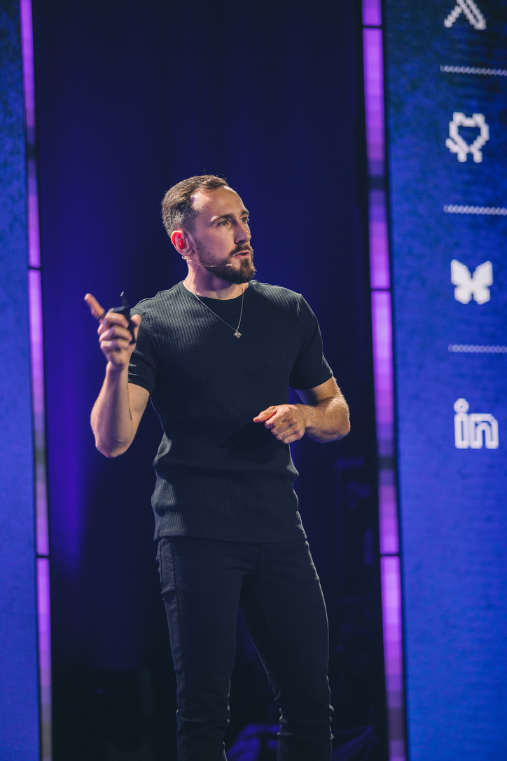 Szymon Chmal speaking on stage